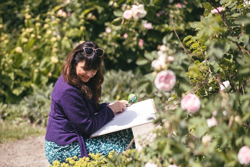 A woman sketches in the grounds of William Morris Gallery - in Lloyd Park, Walthamstow