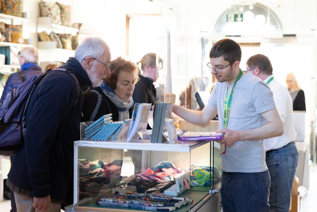 Image of William Morris Gallery staff serving visitors in the Gallery's shop.