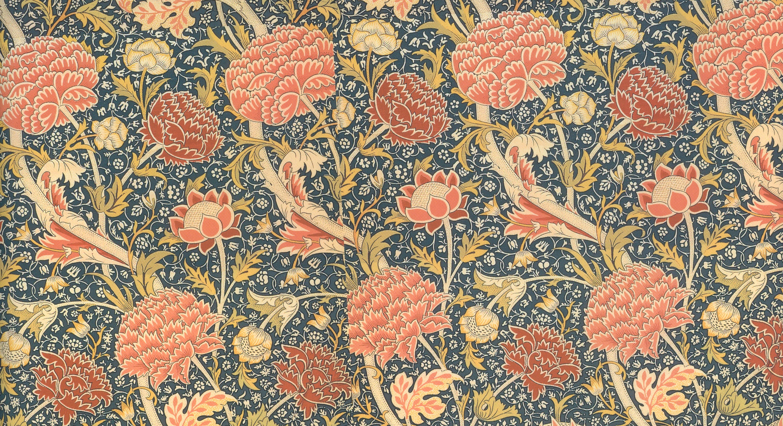 A floral textile pattern in red, pink, blue and gold