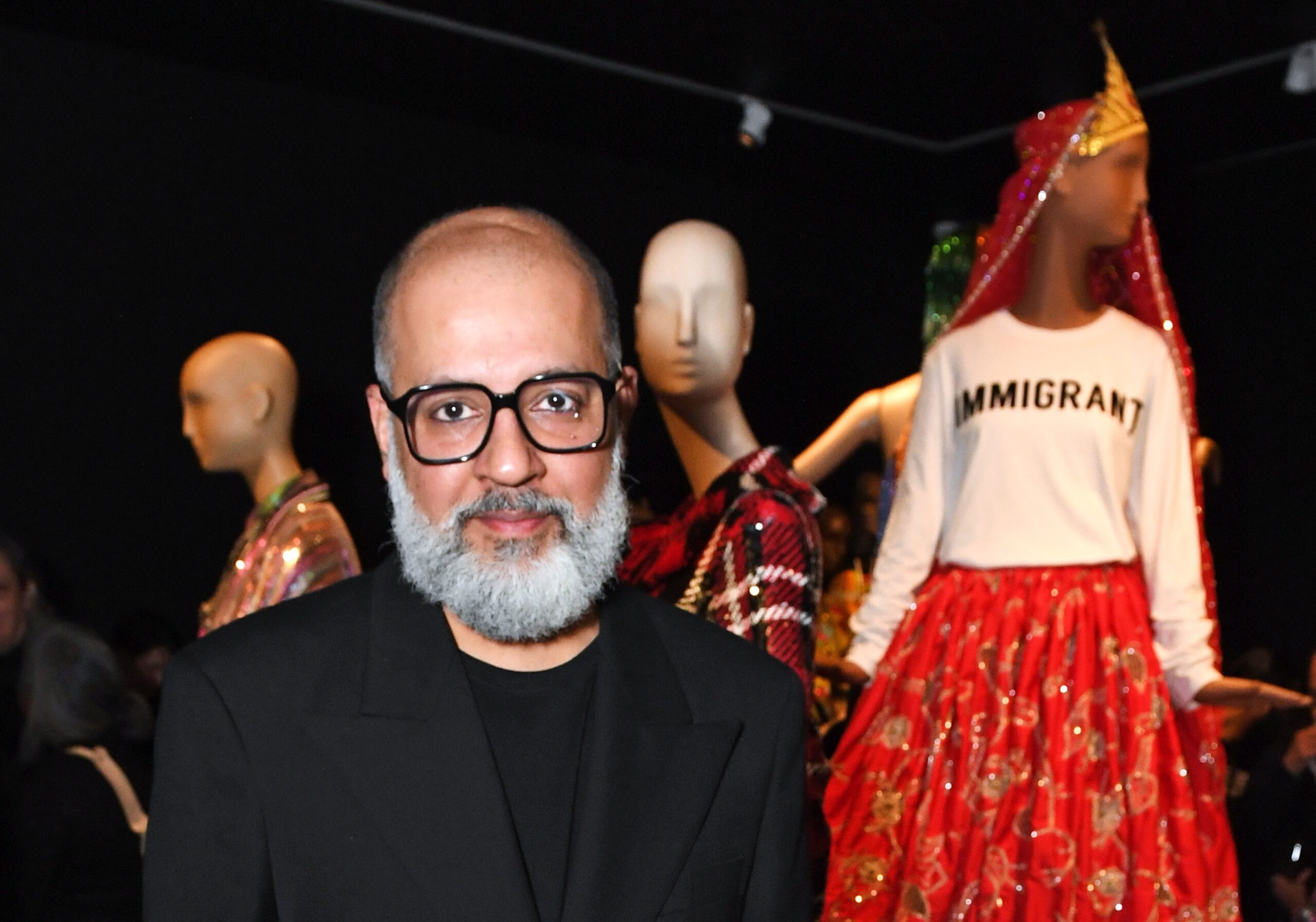 Ashish Gupta at this exhibition with mannequins in the background in Ashish designs