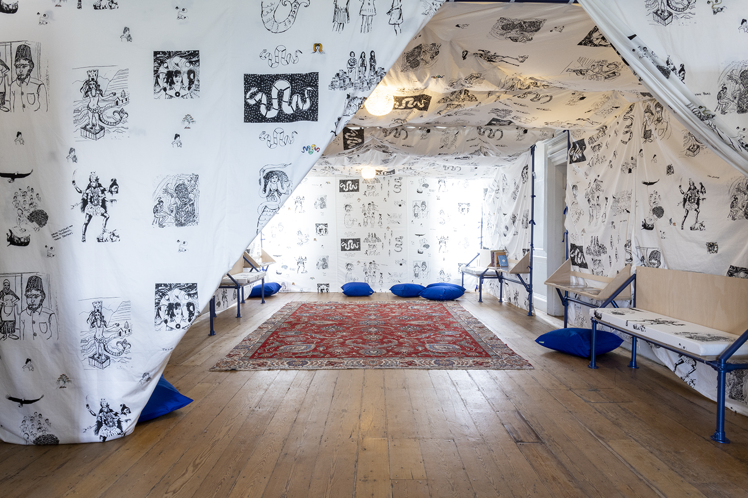 Image of a tented room. The fabric is illustrated with pictures in black and white.