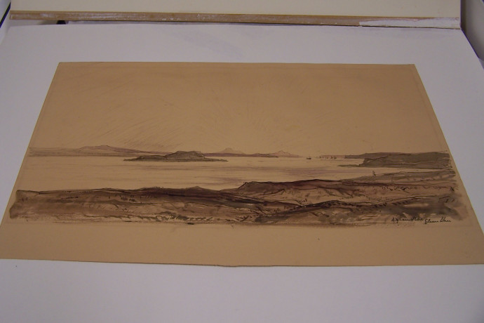 Small island in bay with low hills around