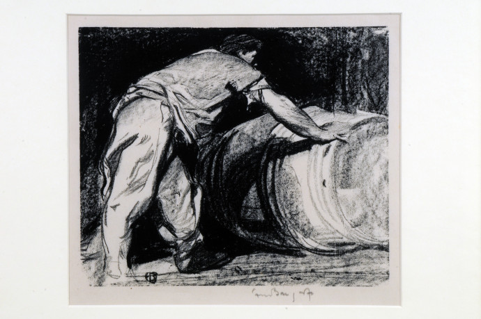 Man rolling a large barrel