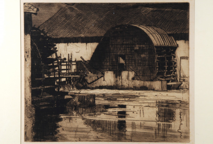 Building with covered waterwheel , with waterway and corner of waterwheel at left front