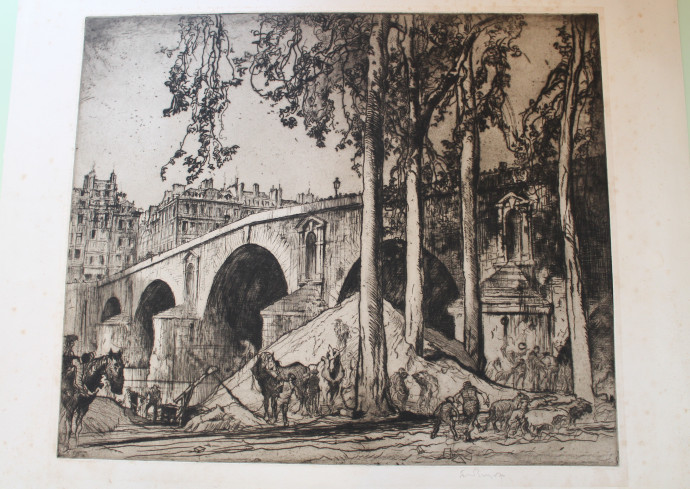 Image of arched bridge spanning river, workmen with horses unloading sand from piles under trees foreground, buildings in background