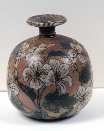 Vase is etched in a decorative floral pattern