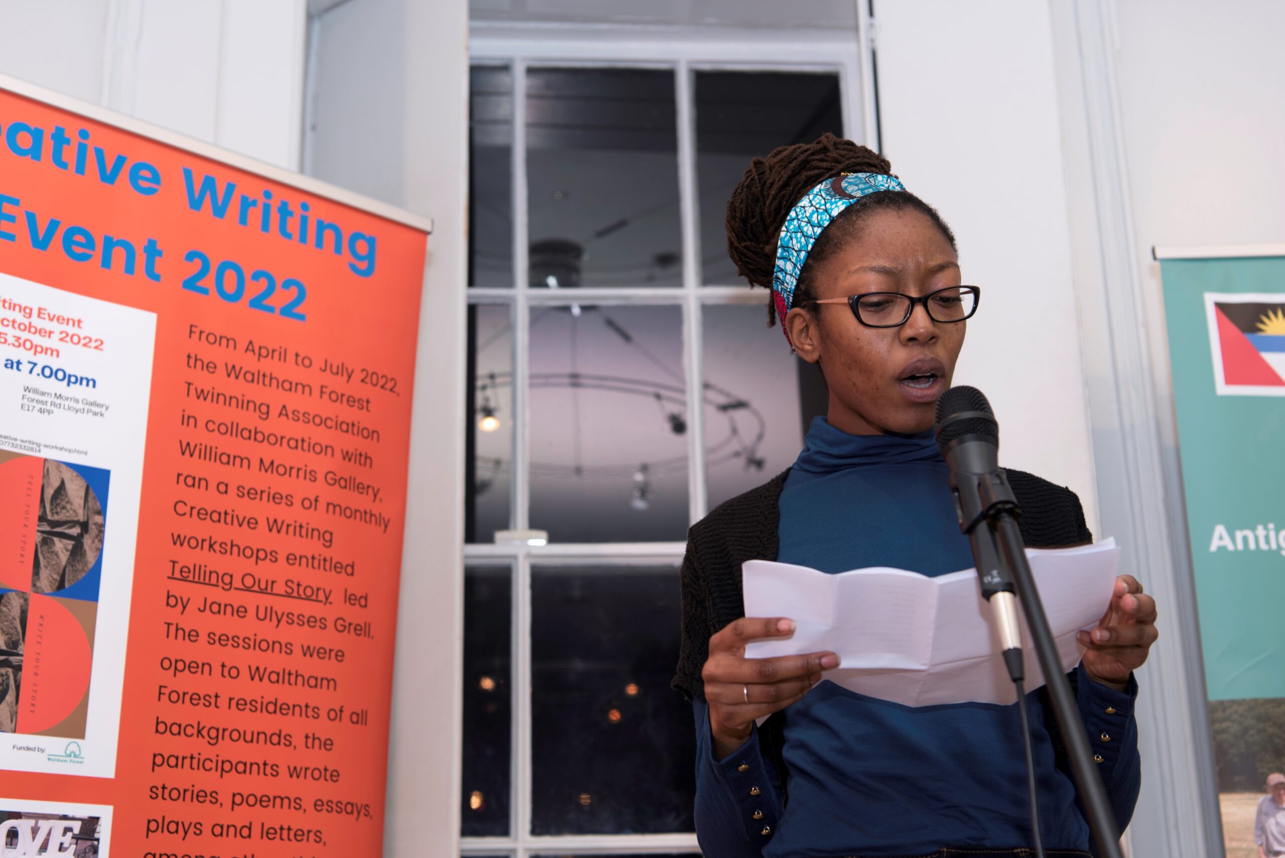 A woman reading at a workshop