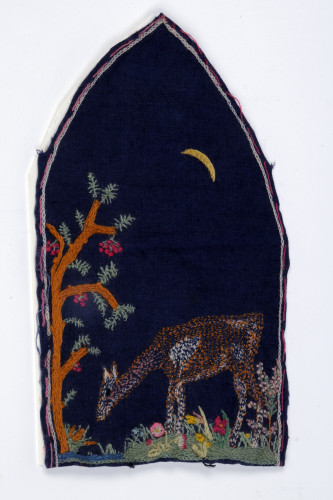 dark blue fabric with embroidery of deer and tree