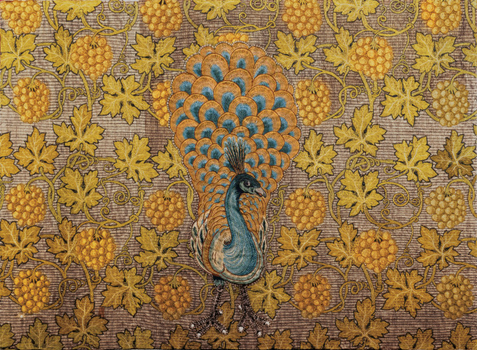 embroidered panel of a peacock surrounded by vines