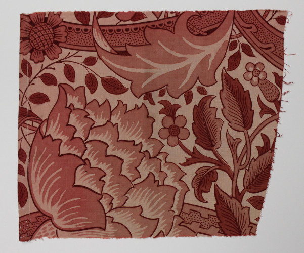 Fabric fragment featuring twisted stems and large elaborate flowers in shades of red.