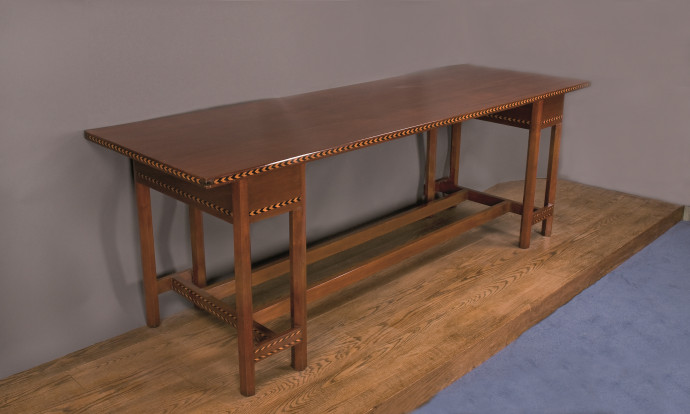 Mahogony table decorated with inlaid chevrons