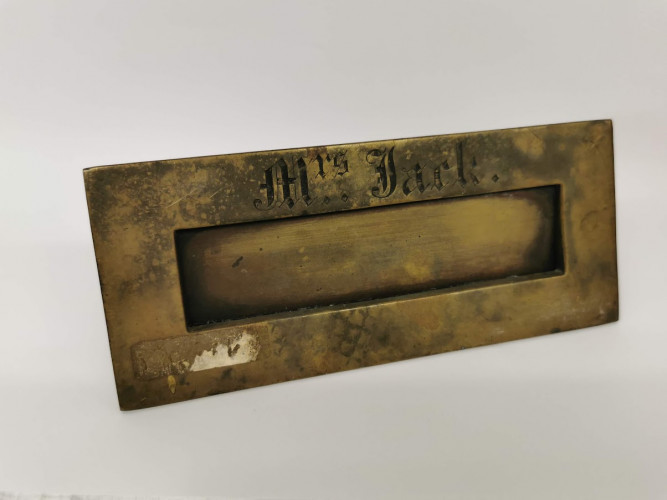 Metal letterbox inscribed 'Mrs Jack' in gothic font