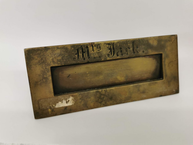 Metal letterbox inscribed 'Mrs Jack' in gothic font