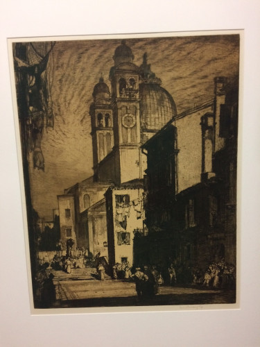 procession crossing sunlit bridge as crowd look on with church beyond