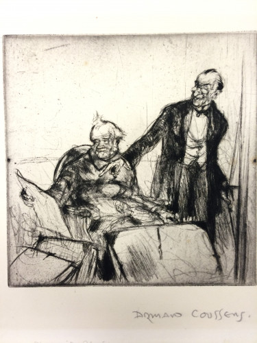 man sits at table looking at prints whilst second man stands and looks on