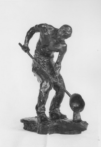 Man stripped to waist, wearing trousers and braces, holding long pole with ladle attached from which he pours iron. Front view.