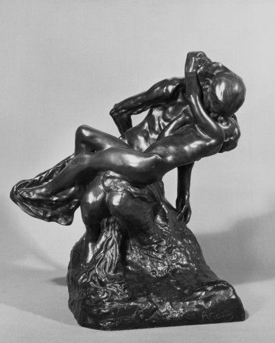 Two figure bronze group of an old woman seated behind embraced by nude figure of a young girl who reclines across her knees. Front view.