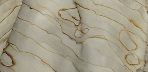 Close up on cream material with burn marks across it