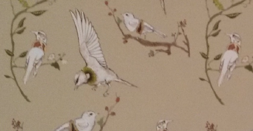Repeating wallpaper pattern of delicate birds in flight and on tree branches