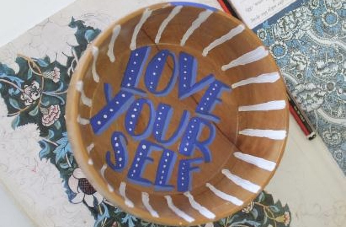 Close up on a decorated bowl bearing the words Love yourself